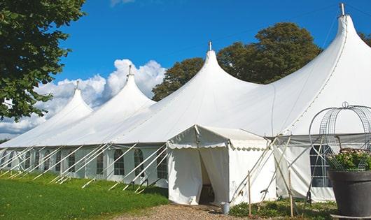 tall green portable restrooms assembled at a music festival, contributing to an organized and sanitary environment for guests in Burrillville RI